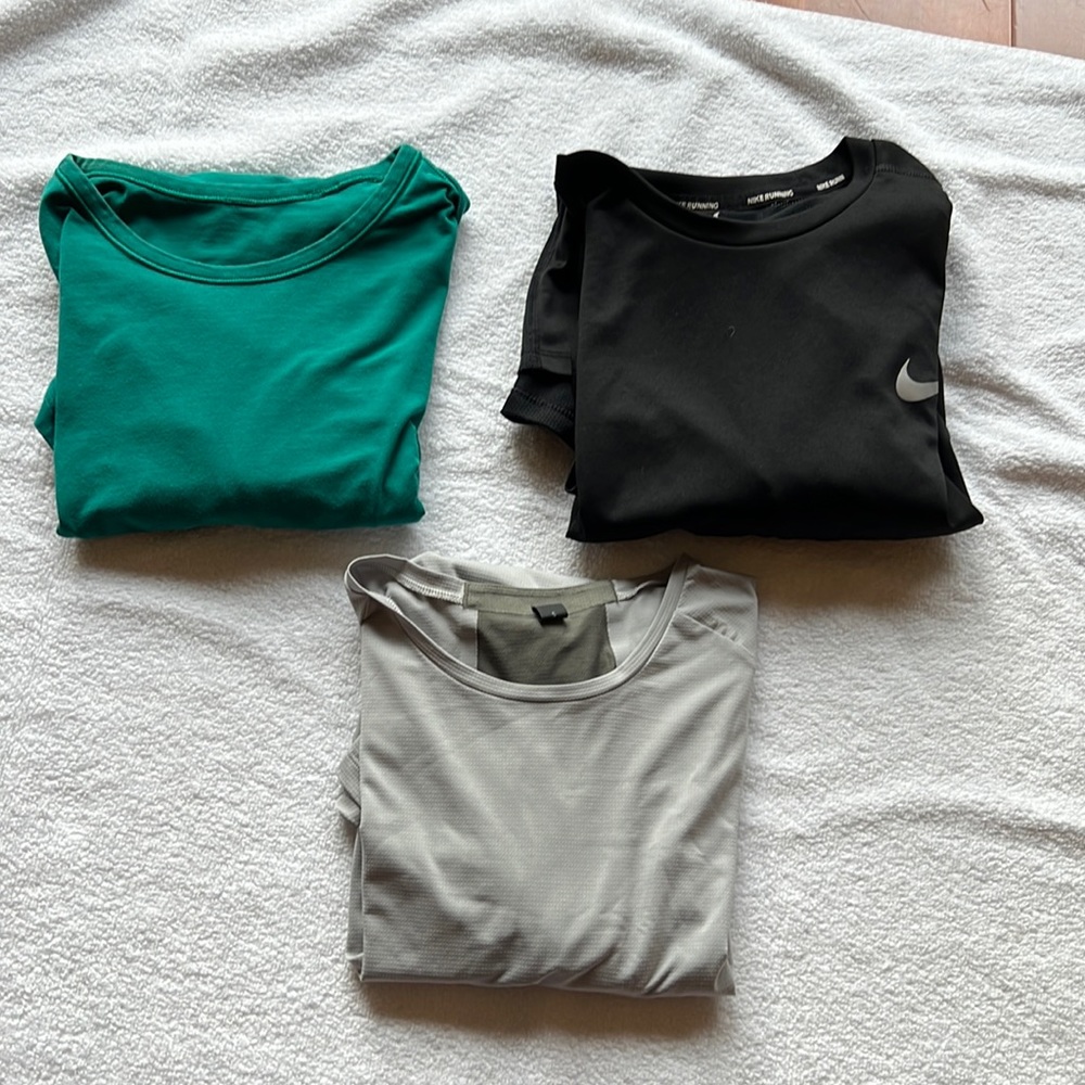 Three mens size small shirts: 2 short sleeve Lululemon. 1 long sleeve Nike black